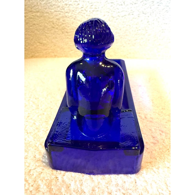 Blue glass bathing beauty. Cobalt blue glass dish. She glows. She is 6 x 2.5 x 4 inches tall. In great condition. Marked...