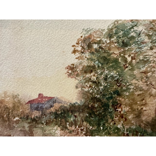Original watercolor on textured paper attributed to Frank Henry Mason, depicting a tranquil waterside landscape with a...