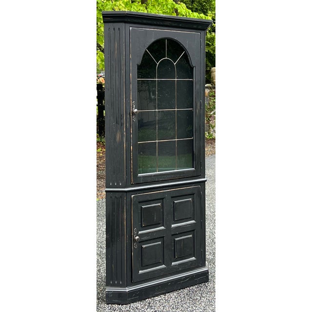 Farmhouse style oak corner cabinet in a distressed black finish by Broyhill furniture from their popular “Attic Heirlooms”...