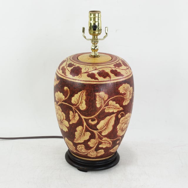 This striking vintage table lamp features a classic ovoid ceramic body meticulously hand-painted with a traditional floral...