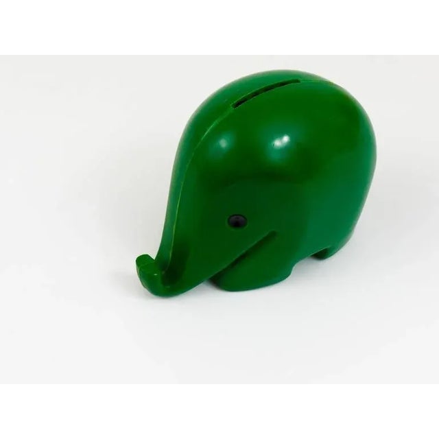 A charming and beautiful green elephant piggy bank, named "drumbo" with key and key ring from the 1970s. Designed by Luigi...