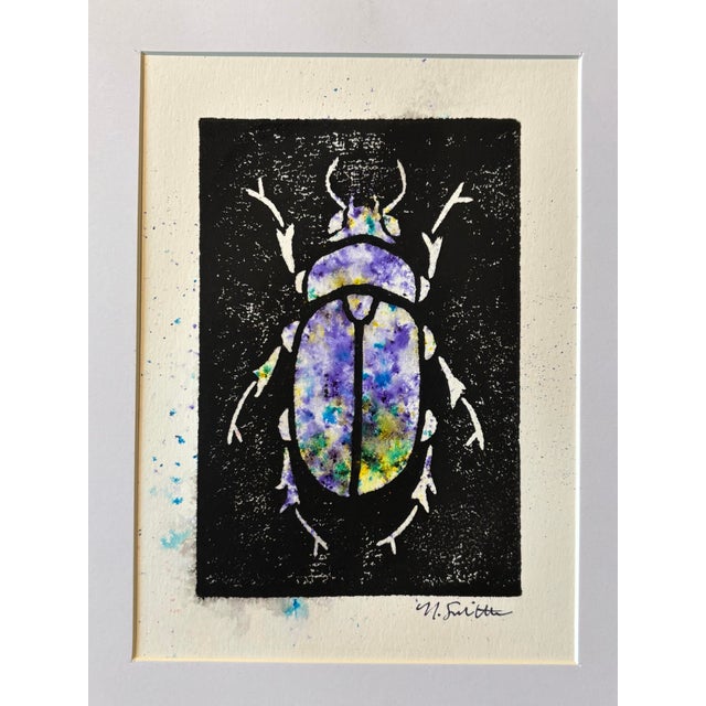 An original hand-carved block linocut featuring a detailed beetle motif, individually printed with black ink and finished...