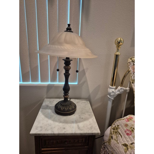 This is a matching pair of traditional-style banker/accent table lamps featuring an elegant combination of classic...