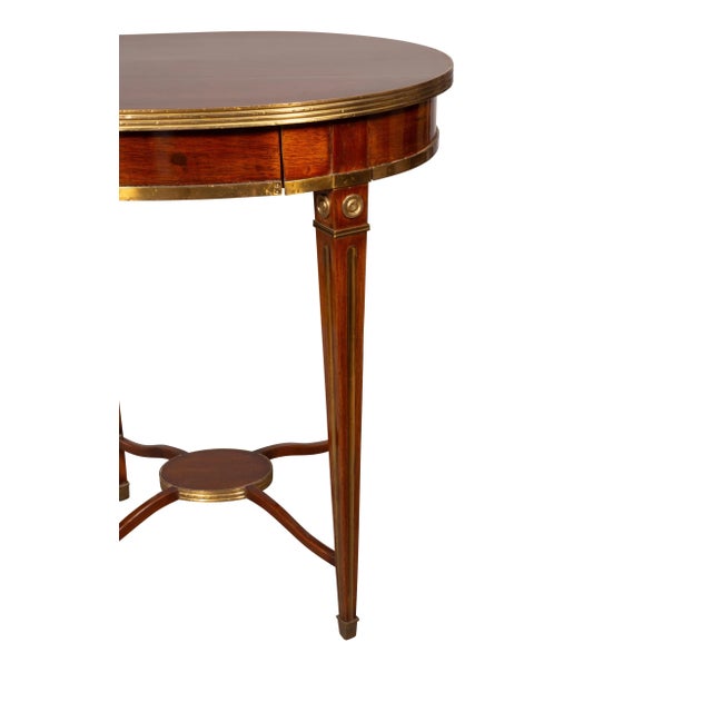 Circular top with brass banding over a drawer within the frieze. Brass bosses at top of square tapered legs with...