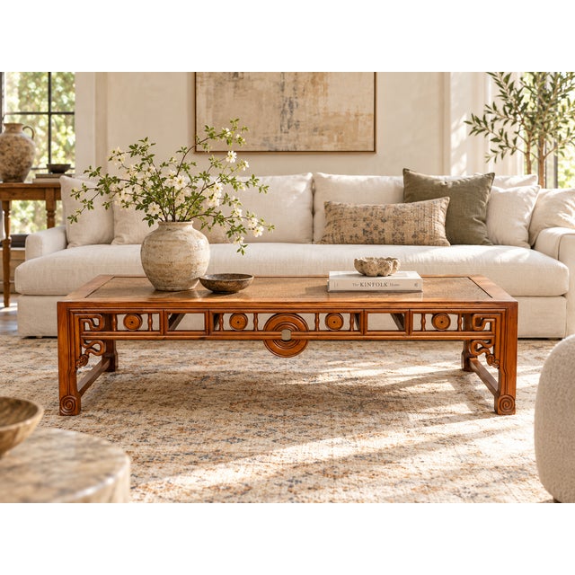 An antique Chinese bed, cut down and made into a long, low coffee table. The woven seat now serves as the top, set within...
