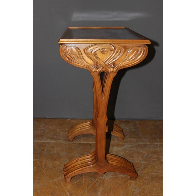 A set of four nesting tables, each signed Gallé, with beautiful Art Nouveau walnut bases decorated with leaves. The...