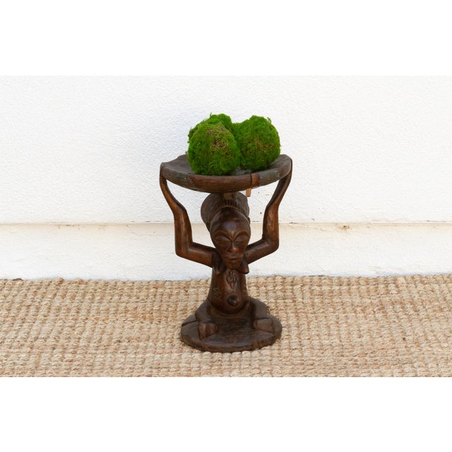 A masterpiece of African art, this antique Luba stool showcases a stunningly carved woman holding up the seat. The wax-...