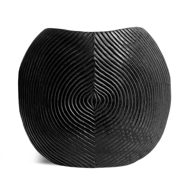 Beautiful hand carved black wood seed scored vase. Modern unique elegant design. Each unique in handmade differences and...