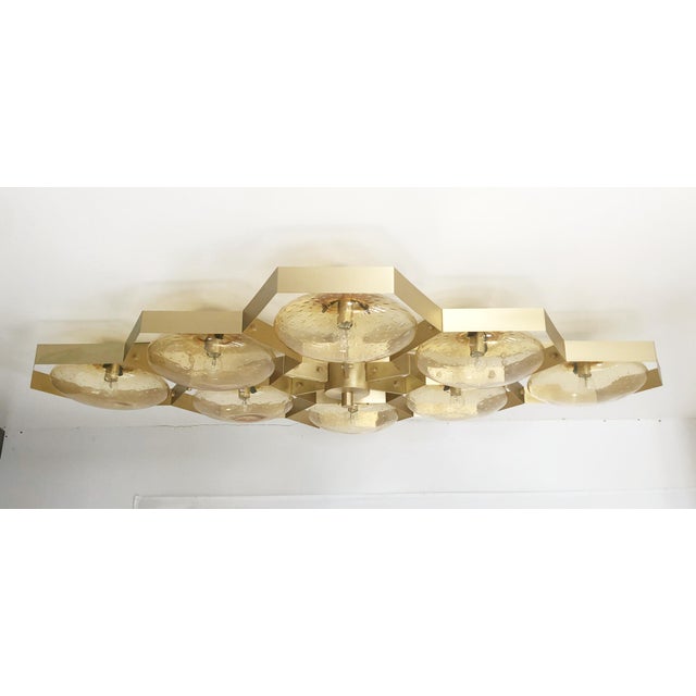 Italian midcentury flush mount with eight amber Murano glass shades carefully hand blown with bubbles inside the glass...