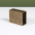 Industrial rectangular brass object. The brutalist form features a hollow center. The geometric block can be used as a...