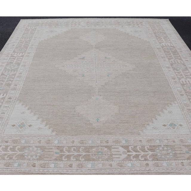 Measures: 10'0 x 14'4 Oushak Rug with a Taupe Base and Soft Ivory, Light Blue Accents 10'0 x 14'4. Keivan Woven Arts. rug...