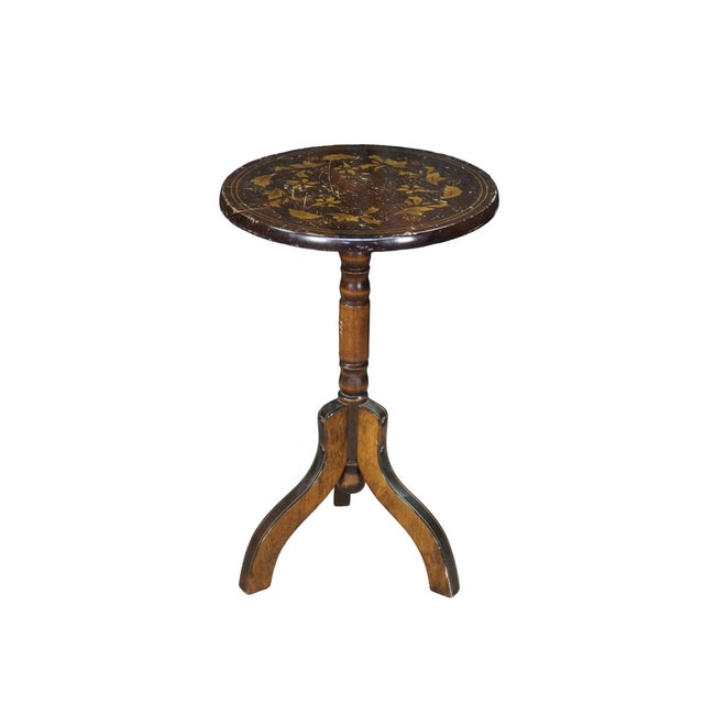 This vintage teak Federal style tilt-top table features a round top with a gold painted leaf design supported by a turned...