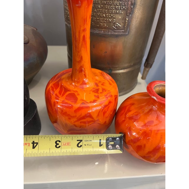 Up for consideration is a beautiful vintage pair of orange ceramic vases. These would look lovely in your home and they...