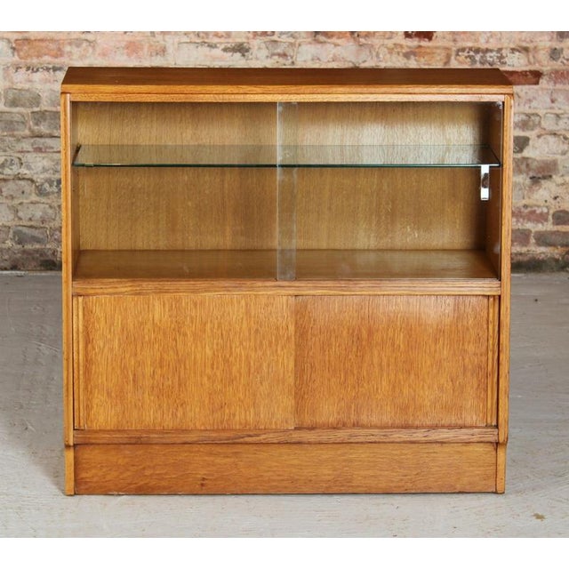 Mid Century G-plan Brandon range oak bookcase, circa 1950s. Sliding glass doors on the top and sliding wooden doors on the...