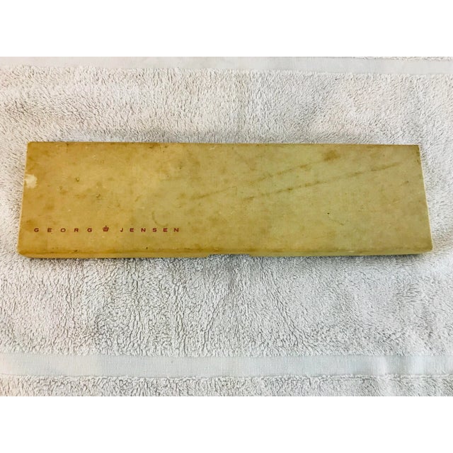 Still in original box. Beautiful carving set. Marked Georg Jensen, Denmark. Stainless steel with rosewood handles....