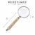 A beautifully crafted decorative magnifying glass featuring a richly carved bone handle with intricate floral relief...