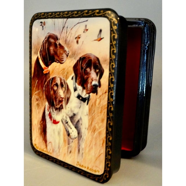 Celebrate the artistry of Russian craftsmanship with this vintage papier-mâché lacquered box, adorned with a sporting dogs...