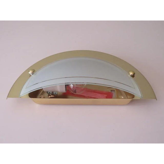 Gold-colored metal frame with etched white glass chalice. The lamp has a 1 E 27 porcelain socket and is labeled with the...