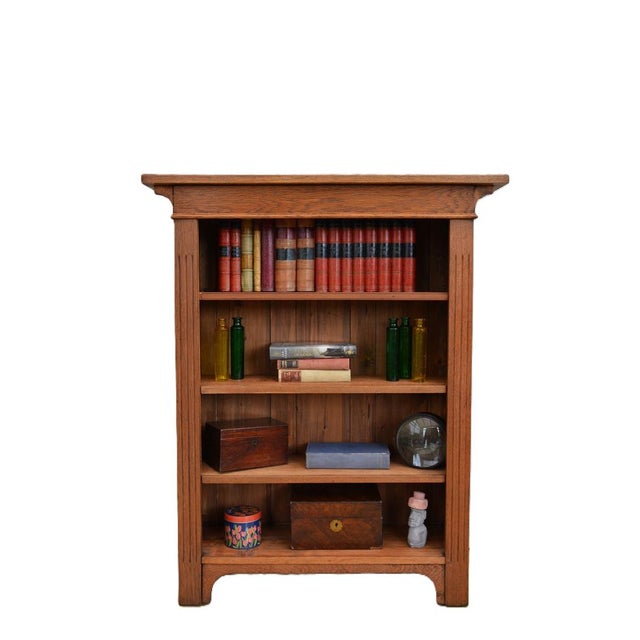 P0327 english antique arts and crafts solid oak bookcase of narrow proportions, having single piece of timber, oversialing...