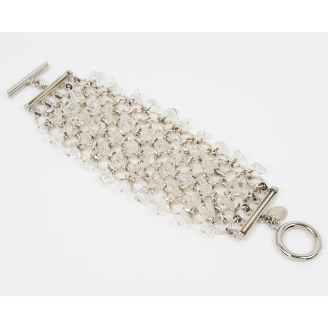 This gorgeous Paco Rabanne Paris futuristic link bracelet features a massive silver-tone chainmail grid ornate with dangle...