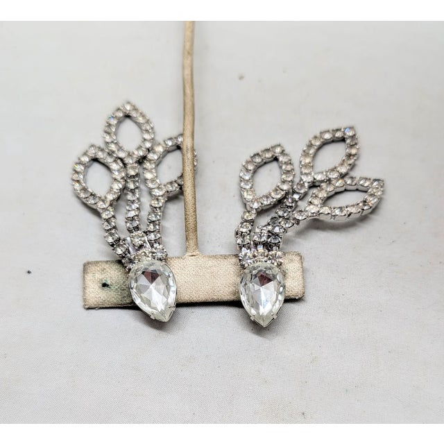 1980s rhodium plated prong set pear shaped top with round clear rhinestones drop with pointed ellipse shapes at the bottom...