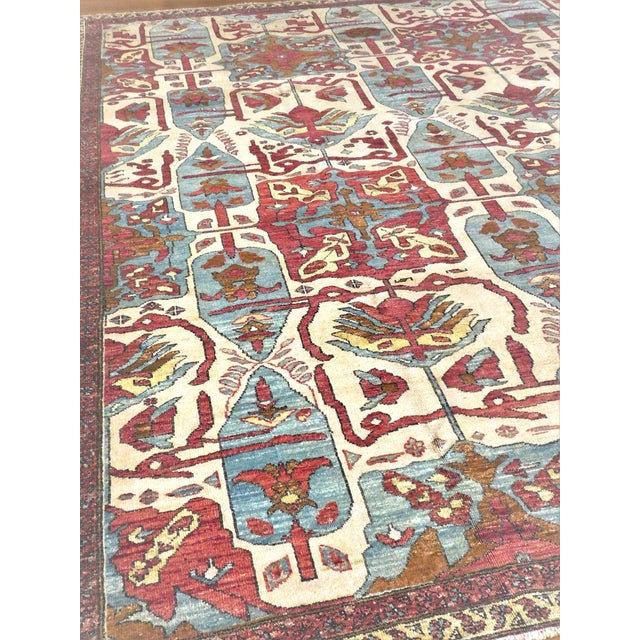 An exceptional hand knotted antique re-creation rug, featuring architectural elements and grand scale tribal motifs. Hand...