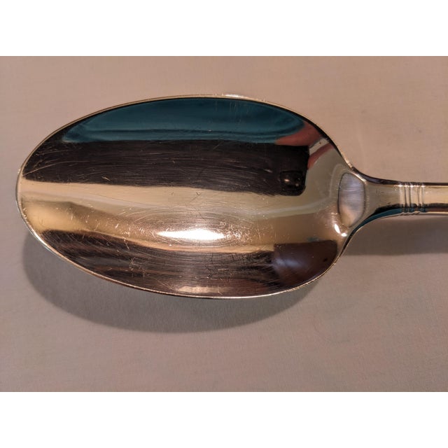 A sterling silver tablespoon/serving spoon by Tiffany in the simple but elegant "Windham" pattern measuring 8 5/8 inches...