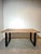 Beautiful contemporary dining table with a solid wood “live edge” top and sleek black metal U-shaped legs. The organic...