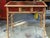 This is a Victorian chinoiserie and burnt bamboo red lacquer side table or desk. I believe the panels are antiques that...