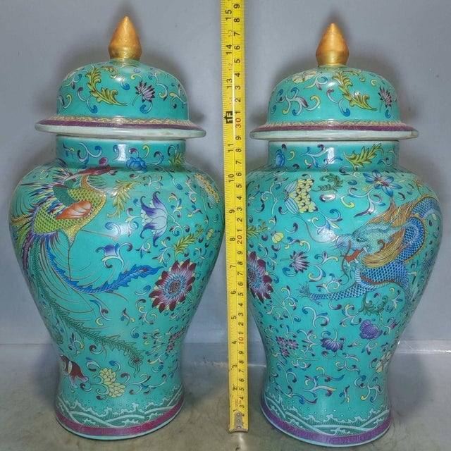 A beautiful pair of Chinese enameled porcelain "General Jars." These vibrant vessels feature a turquoise ground decorated...