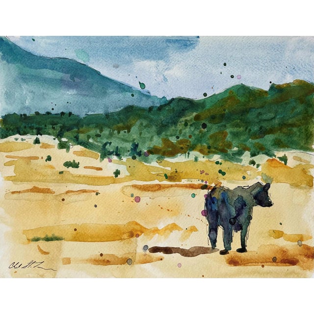 This watercolor depicts a solitary figure of a cow in a vast, sunlit landscape, surrounded by rolling hills and a soft,...