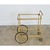 An elegant, mid-century French brass and transparent glass bar cart in the style of Maison Jansen, that would be...