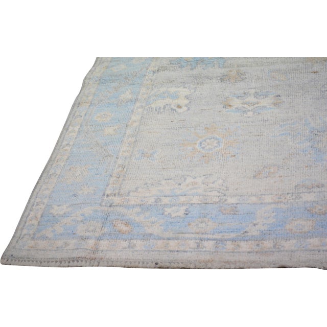 Hand-knotted with care using traditional rug making techniques, this wool rug blends timeless craftsmanship with a modern...