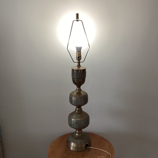 The Vintage Asian Inspired La James Mont Style Intricately Carved Brass Lamp from the 1940s is a stunning piece that...
