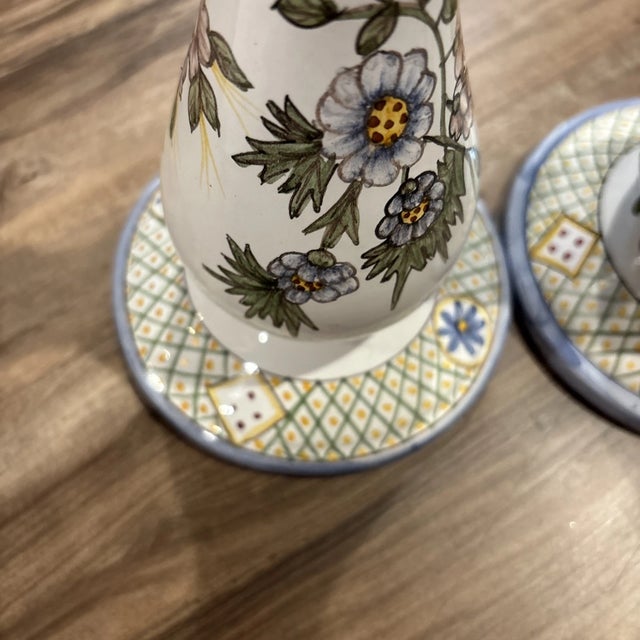 Beautiful vintage set of two candlestick holders featuring a delicate hand-painted floral design. Crafted in Portugal,...