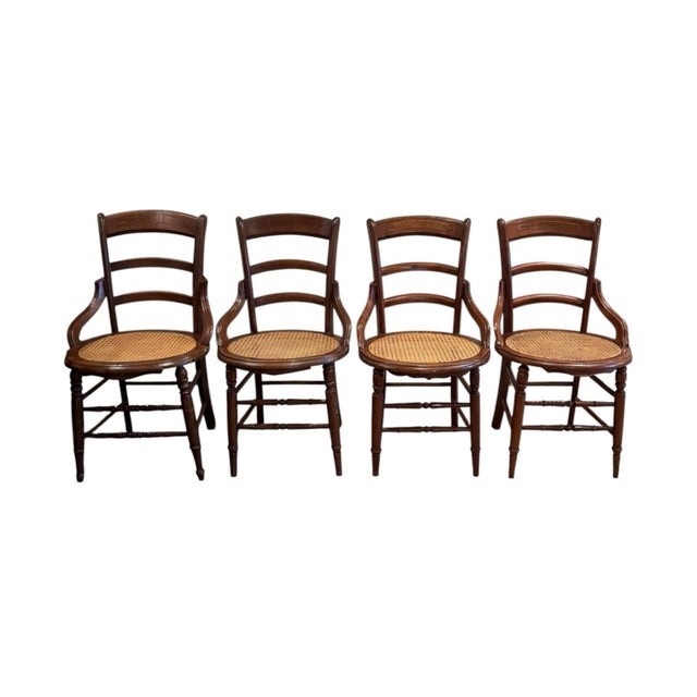A set of 4 Victorian style ladder back side chairs made of mahogany with hand caned seat and backrests. Each chair...
