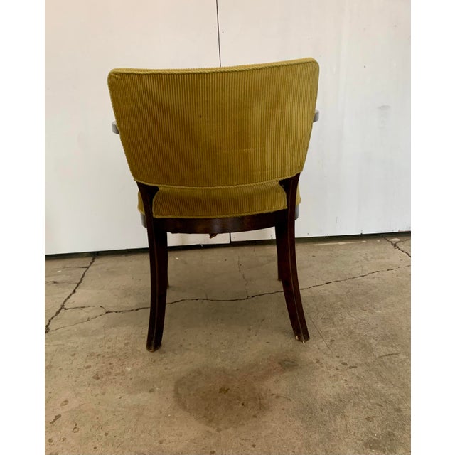 A pair of stained beech armchairs, seat and back covered with green/yellow velvet, Fritz Hansen, first half of 1900's....