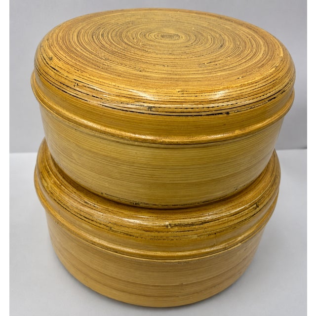 A striking set of five Oggetti graduated round lidded boxes handcrafted from tightly coiled bamboo strips with a warm...