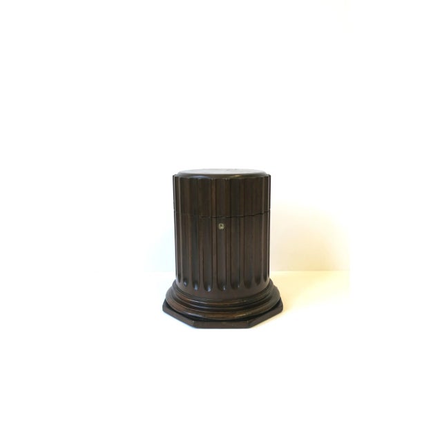A fluted wood pillar column pedestal box in the Neoclassical style, circa mid-20th century, USA. Piece is a rich dark...