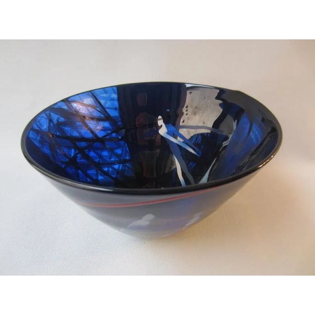 Exceptional bowl made of layered glass with three stylized floating figures, artistically shaped, cut and etched. After...