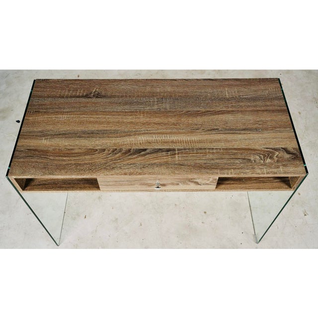 Clean-lined, architectural, and effortlessly versatile, this modern writing desk pairs warm woodgrain surfaces with sleek...