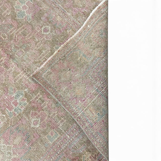 An antique hand-knotted Azeri rug, professionally antique washed to create a beautifully faded palette of warm beige, soft...