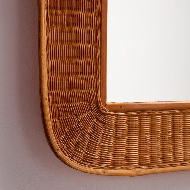 A handcrafted rattan mirror with organic shapes from the 1970s.