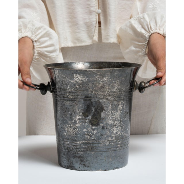 This mid 20th century ice bucket from Italy is finished in silver. Its form follows honest, well-proportioned lines...