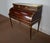 This cylinder desk has two drawers in the waist, with solid mahogany fronts with reserve, dressed with brass rods in...