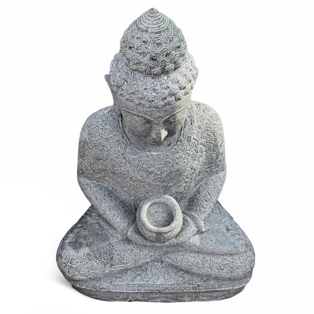 Carved from solid stone, this sitting serene Buddha statue brings a sense of tranquility and to any space. Featuring...