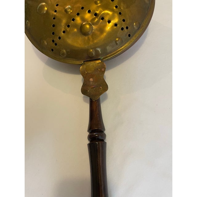 19th century antique brass and copper bed warming pan with turned brown lacquered handle. Pierced star motif and raised...