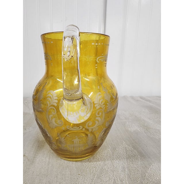 Home Inspirations is proud to offer this gorgeous pitcher etched with a village and woodland creatures. When not in use it...