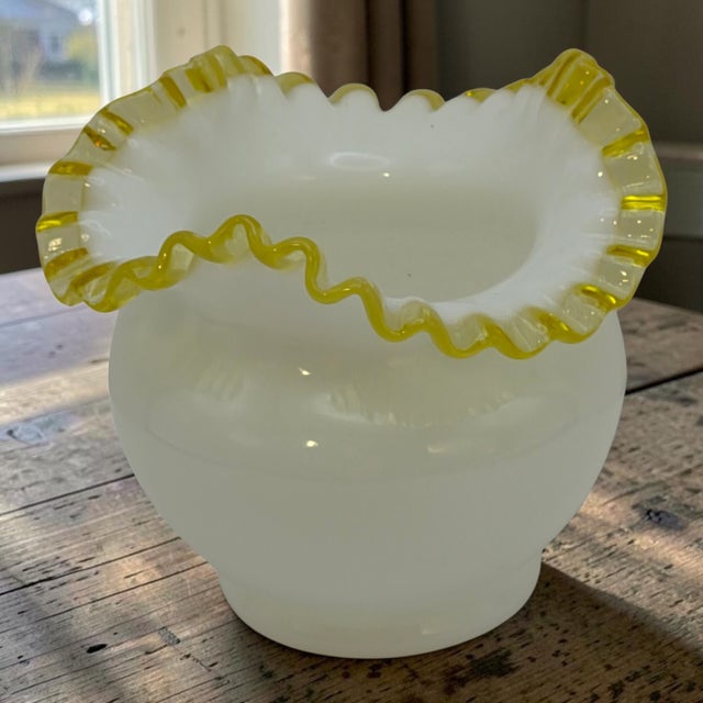 The Vintage Fenton Milk-Glass Crimped Ruffled Amber Yellow Edge Rose-Bowl Vase is a stunning piece of decorative glassware...