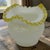 The Vintage Fenton Milk-Glass Crimped Ruffled Amber Yellow Edge Rose-Bowl Vase is a stunning piece of decorative glassware...